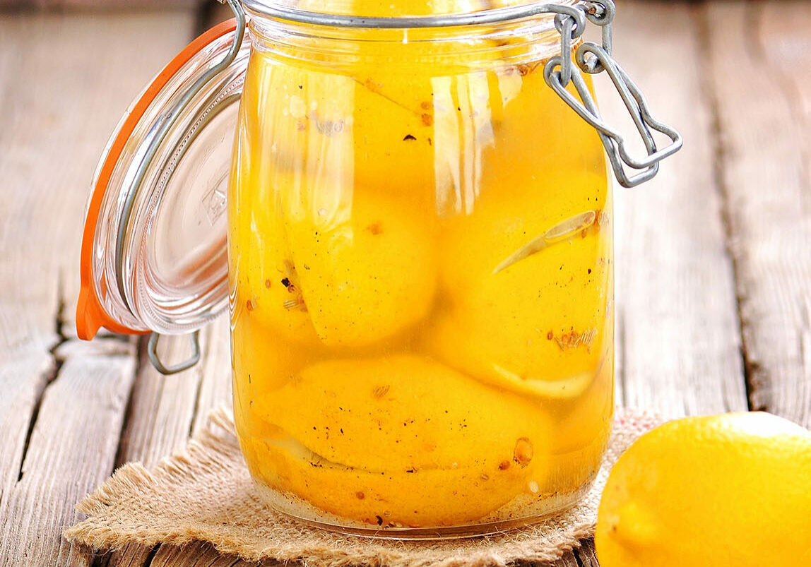 Preserved lemons with sea salt and spices. Moroccan cuisine. Vintage style.